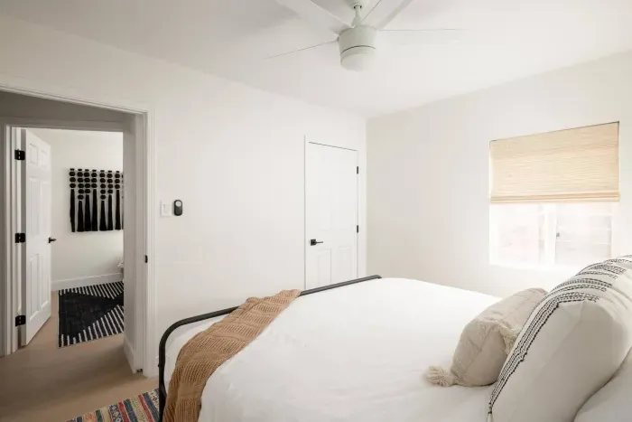 Relax in a bright, minimalist bedroom complete with blackout shades and premium linens.