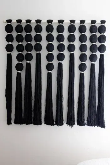 Modern wall art provides a bold yet minimal backdrop to the home’s neutral palette.