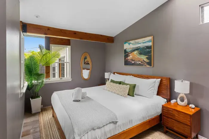 Bright guest suite with king bed and ocean tones