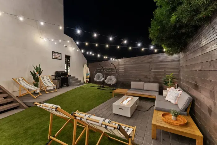 Evening backyard ambiance with fire pit and lights