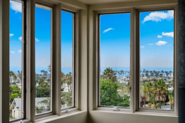 Bay window with sweeping treetop and ocean views