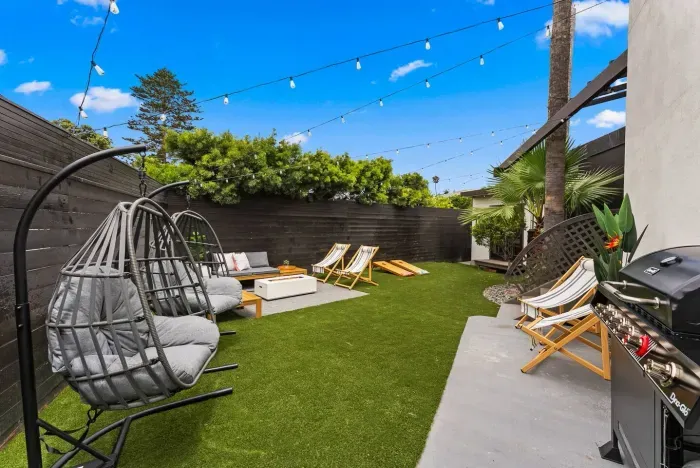 Relaxing backyard with fire pit and lounge chairs