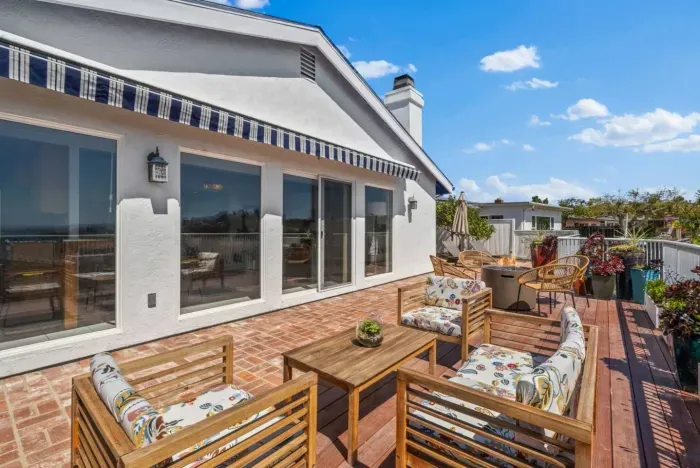 Soak up the sun and unwind on this stylish Airbnb patio with stunning views and cozy seating