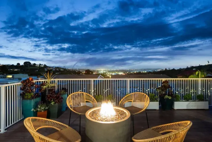 Cozy vibes by the fire with that amazing night view! 