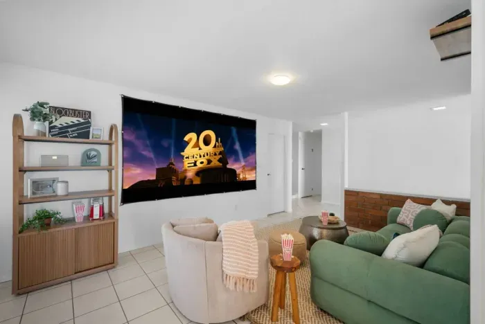 Experience the ultimate movie night in this cozy Airbnb, complete with a big-screen projector and stylish seating! 