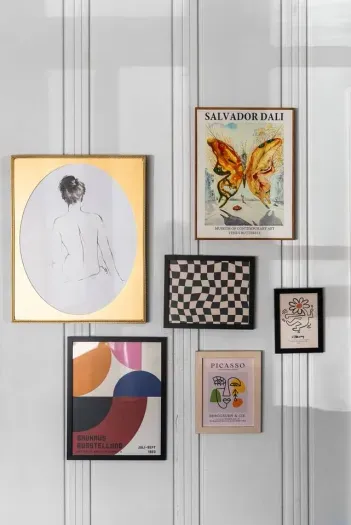 curated gallery wall adding artistic flair and personality to the home’s character-rich paneling.