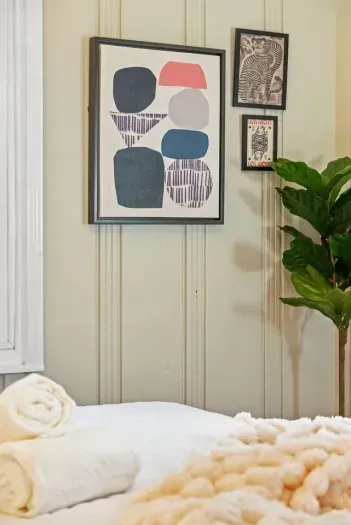 mounted art print adding a modern touch to the classic vertical paneling.