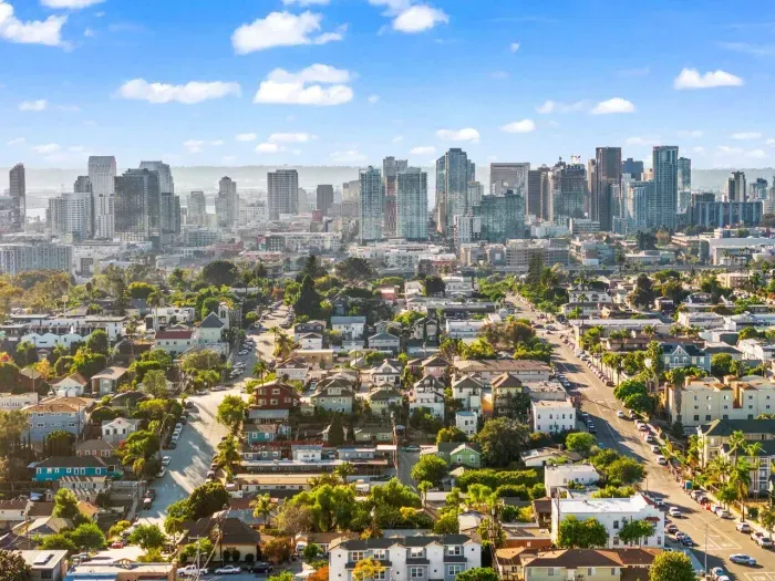 sweeping daytime view of the city with skyscrapers and residential areas rolling into the distance.