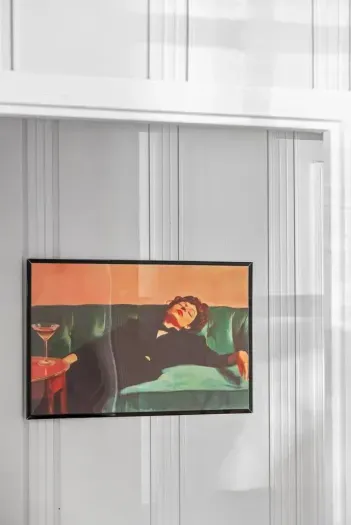 mounted art print adding a modern touch to the classic vertical paneling.