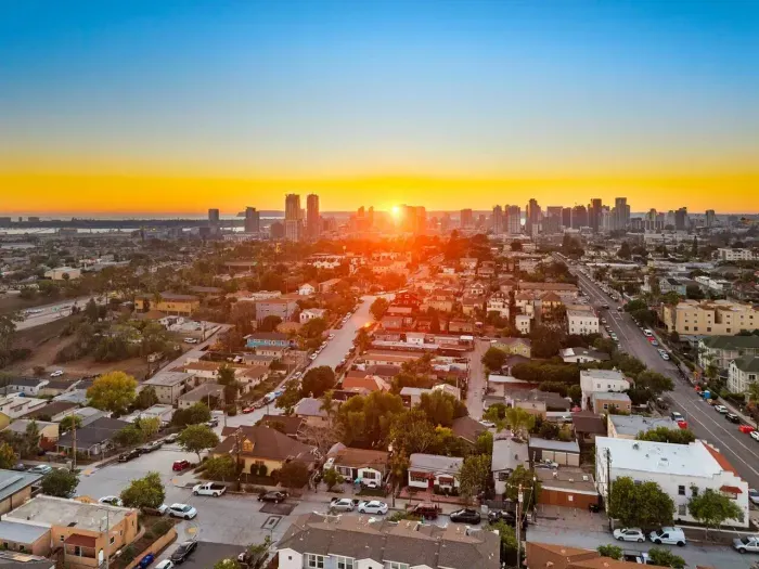 Another stunning sunset view highlighting the neighborhood and skyline in soft evening glow.