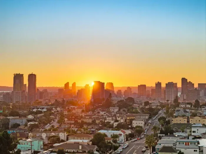 breathtaking sunset view over the city skyline, showcasing warm golden light and expansive vistas.