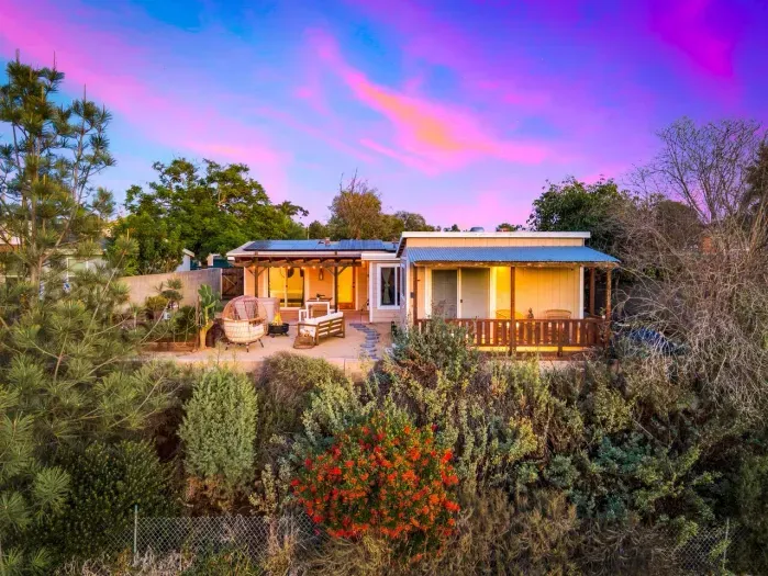 Your peaceful retreat glowing under a stunning sunset sky.