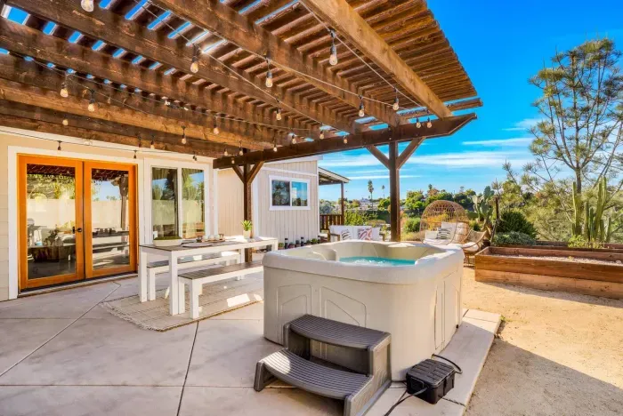 Soak, sip, and unwind under the pergola with gorgeous open views.