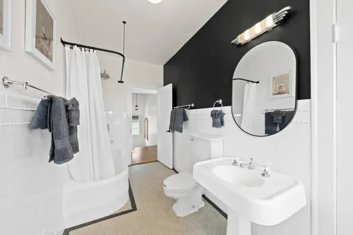 Sleek black-and-white bathroom with character and charm.