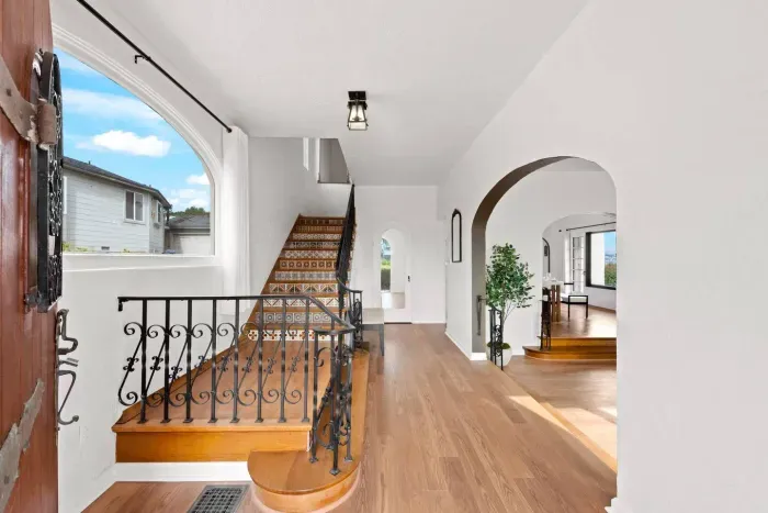 A grand hallway welcomes you with arched charm and timeless warmth.