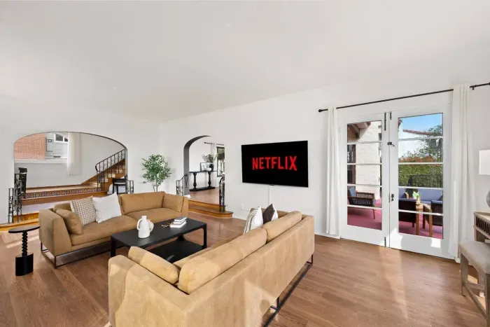 Movie nights feel elevated in this bright living space with city views.