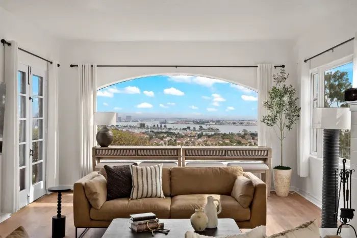 Sunlight pours through arched windows, highlighting every inviting detail.