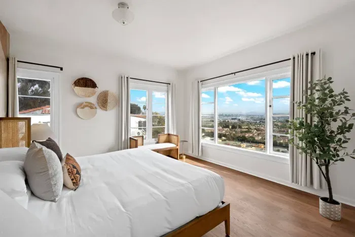 Sunlight fills every corner of this calming, minimalist bedroom.