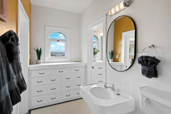 Chic bathroom with ocean light pouring through the window.