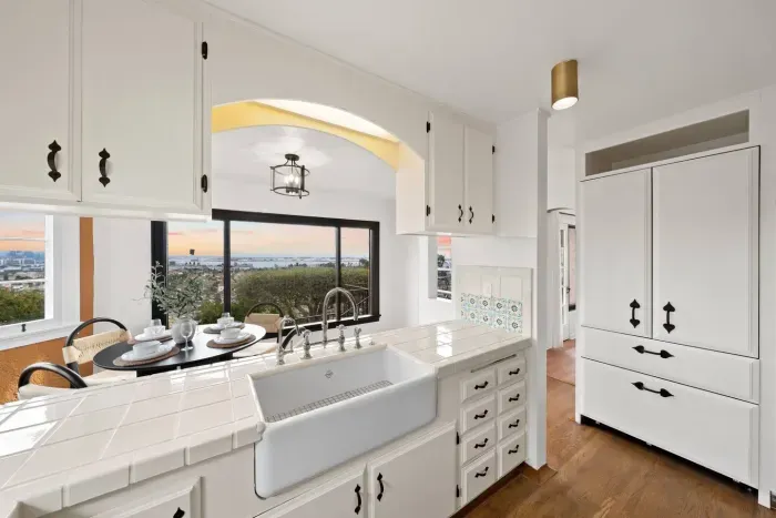 Arched charm and farmhouse touches meet ocean views from the kitchen sink.