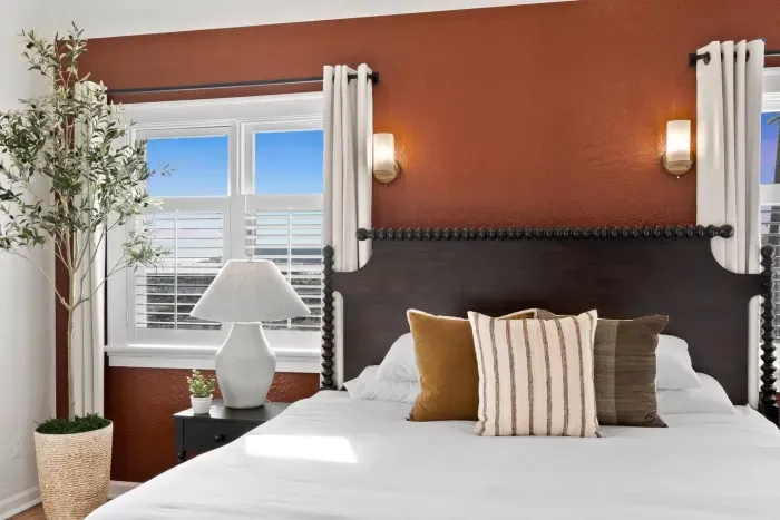 Earthy textures and soft bedding for deeply restful nights.