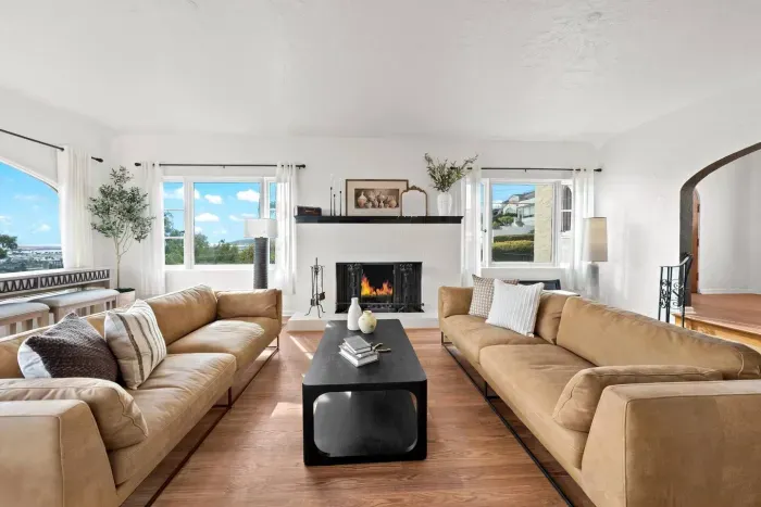 Plush sofas, glowing fireplace, and bright windows welcome you to unwind in total comfort.
