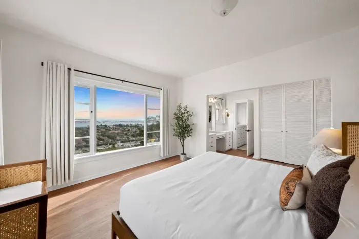 Wake up to sweeping bay views framed by soft light and calm energy.