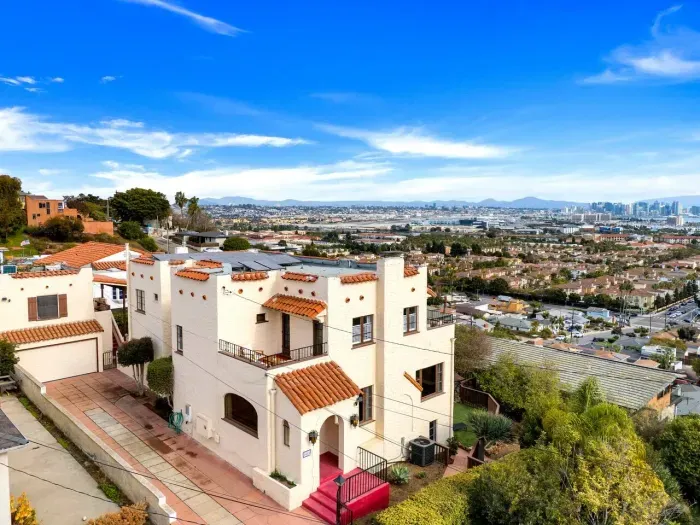 Morning sunlight warms this Mediterranean-inspired home. White walls, terracotta details, and endless city views make every moment feel effortless and bright.