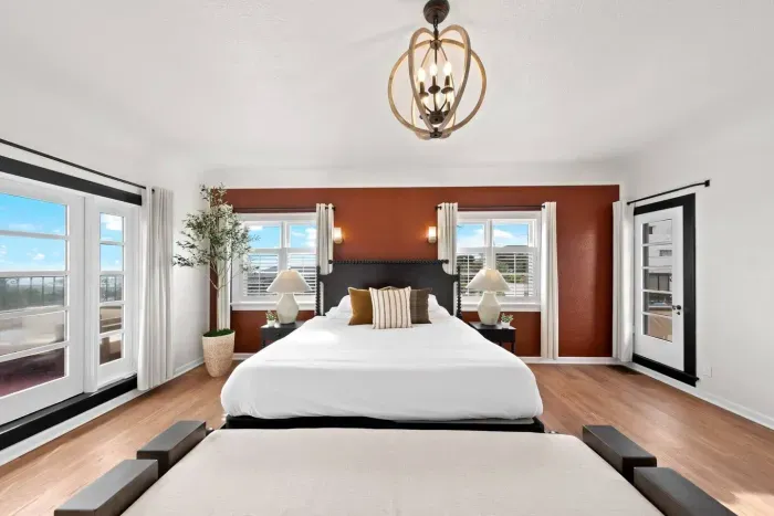 A restful master suite framed by warm tones and coastal light.
