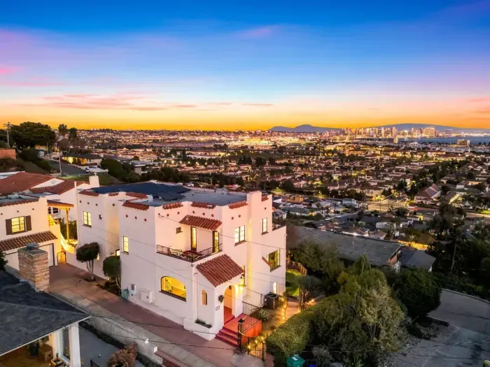 Your hillside villa glows in the soft sunset light. Terracotta tiles, archways, and panoramic views create a timeless scene that feels both luxurious and welcoming.