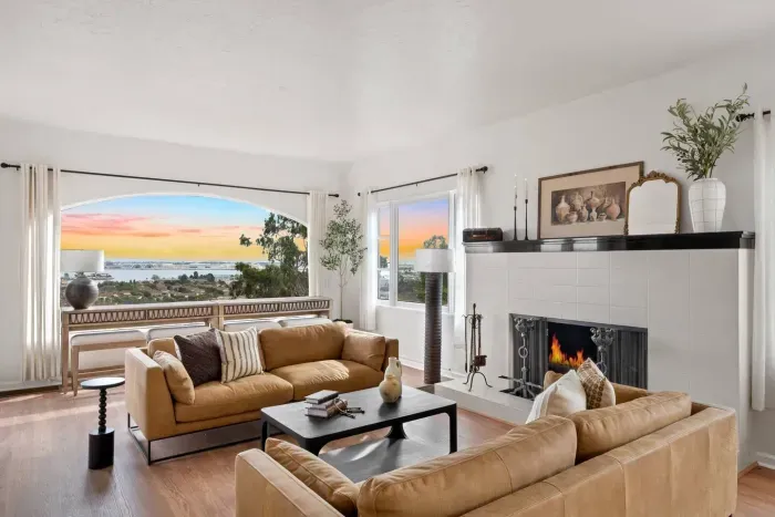 Cozy up in this bright, open living room with plush sofas, a crackling fireplace, and a big-screen TV. The ideal spot for movie nights or morning coffee with friends.