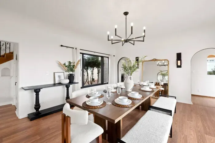 Alfresco dining framed by open arches and golden light.