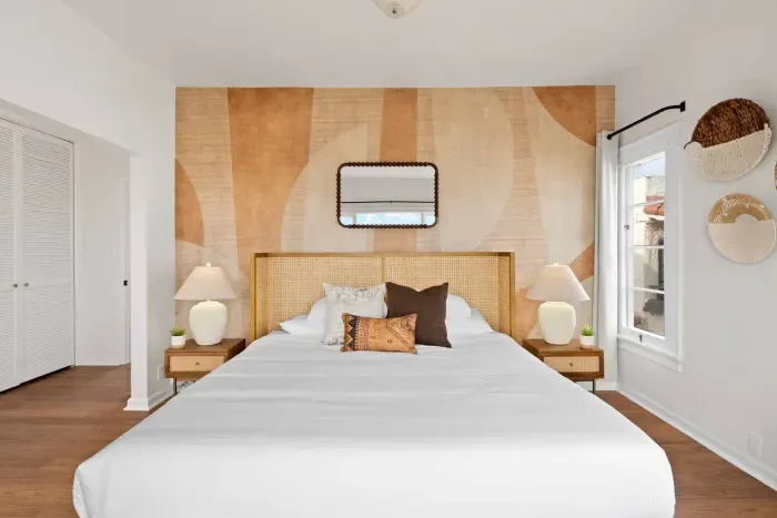 Soft light and natural wood blend for an inviting, grounded bedroom.