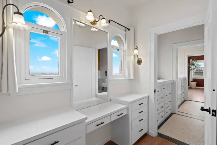 Dual vanities and arched mirrors for effortless mornings.