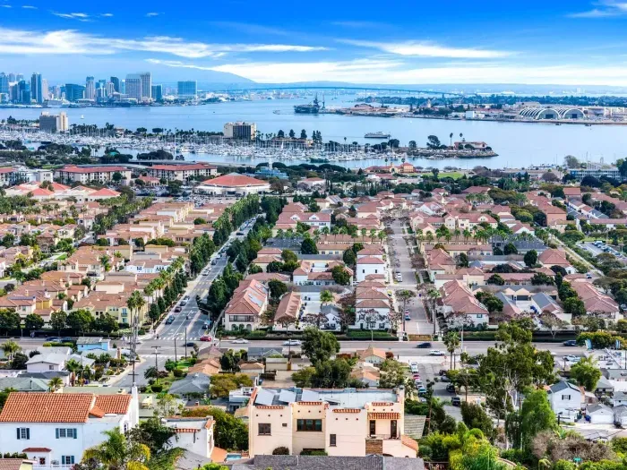 Rows of terracotta rooftops frame the bay, capturing the rhythm of San Diego living from above.