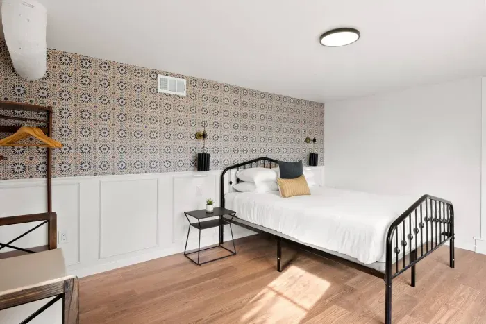 Simple lines, soft wood, and cozy charm fill this serene guest room.