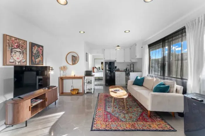 Bright, open living space with cozy vibes and pops of color.