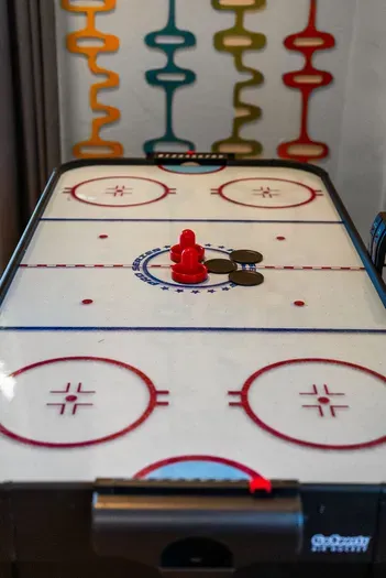 Game room air hockey—fast fun and retro vibes for family tournaments.