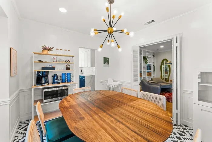 Stylish dining room with coffee bar, seats six, mid-century lighting