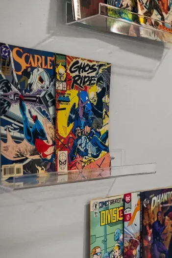 Curated comic book display adds playful, nostalgic flair to the space.