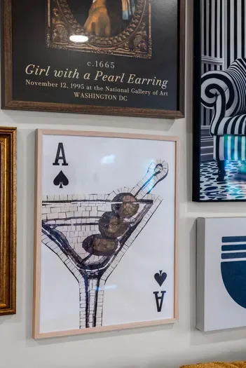 Eclectic gallery wall—cocktail art and classics for a chic, playful vibe