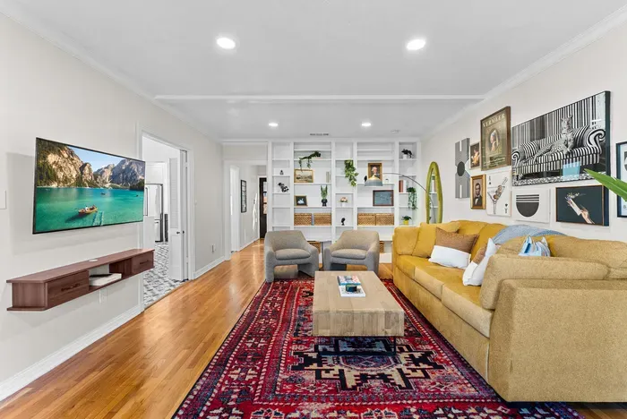 Stylish living room with built-ins, gallery art, and a plush sectional