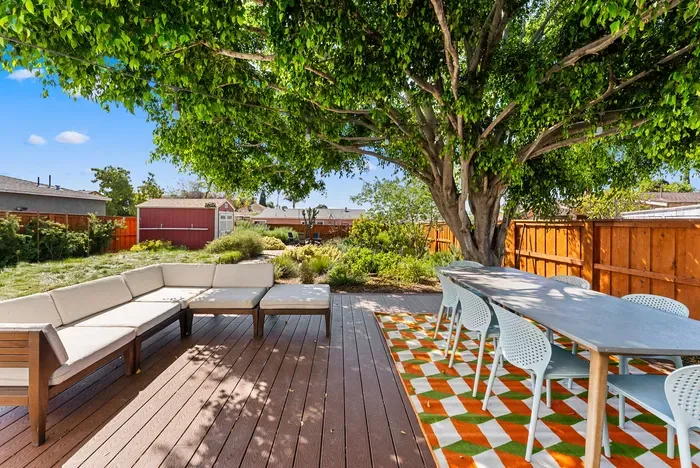 Shaded deck retreat with lounge seating and long alfresco dining
