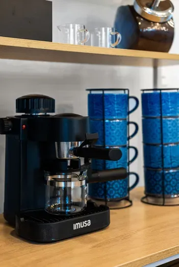 Cozy espresso bar with blue mug sets—fresh shots to start your day.