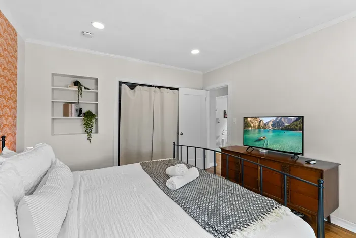 Cozy queen retreat with TV, built-ins, closet and ensuite access