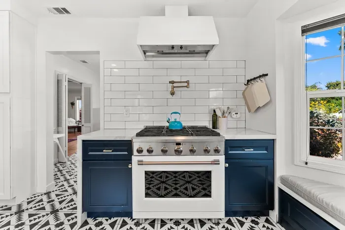 Chef-ready kitchen with pot filler, gas range, and sunny window seat