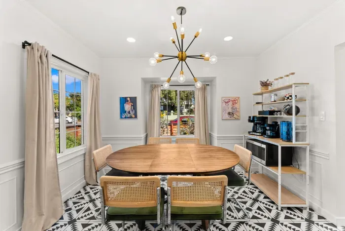 Bright dining room for six with bold tile and a stocked coffee bar