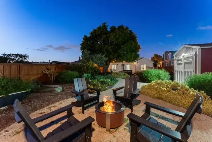 Cozy garden retreat with fire pit and Adirondack seating