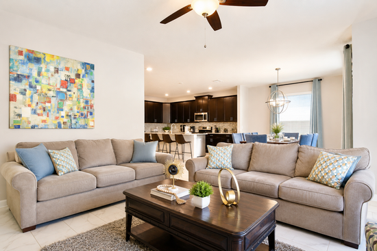 Living room with two large sofas opening to the kitchen and dining area