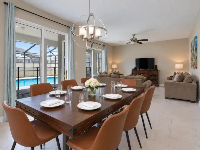 Spacious open dining & living area with pool views and seating for 8